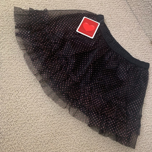 Girls Ruffled Tutu Skirt
Black with pink glittery polka dots 
Condition: NWT - Picture 2 of 2
